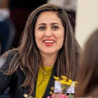 Smiling woman eating lunch